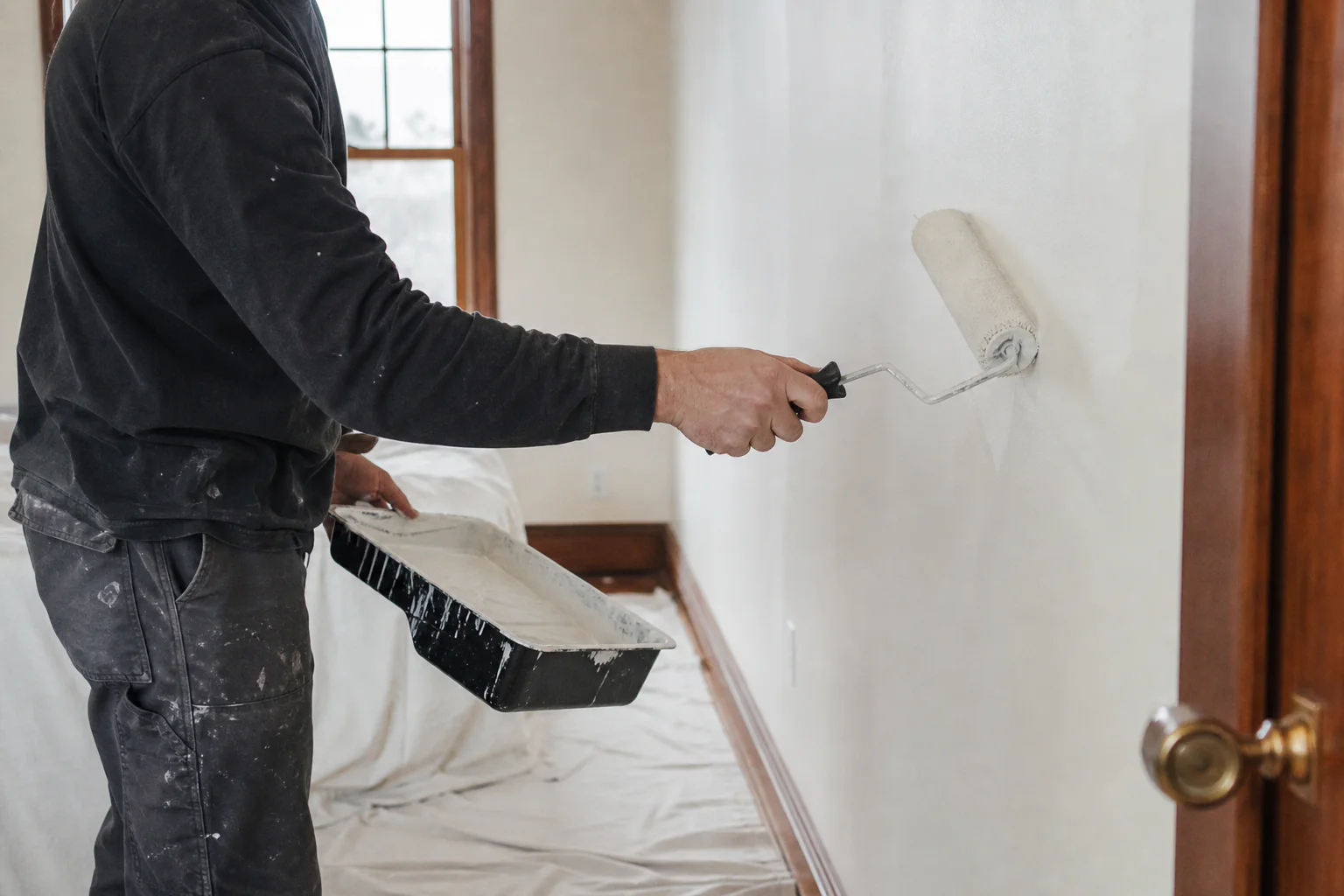 Representative image of an Ottawa painter rolling a warm white interior wall